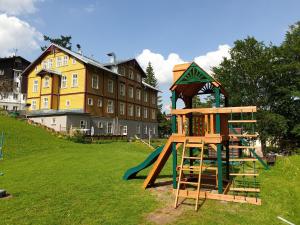 a playground with a slide and a play structure at Pension Janský Potok I. in Janske Lazne