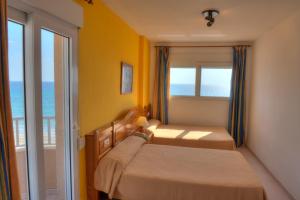 
a bedroom with a bed and a window at Aparthotel La Mirage in La Manga del Mar Menor
