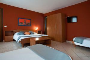 pokój hotelowy z dwoma łóżkami i telewizorem w obiekcie Hotel Oasi Verde w mieście Bienno