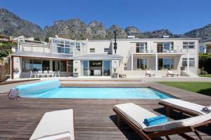 a large house with a swimming pool in front of it at Amber Place in Cape Town