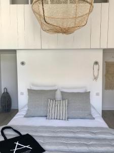 a bedroom with a bed with a basket hanging above it at Antichambre in Nîmes