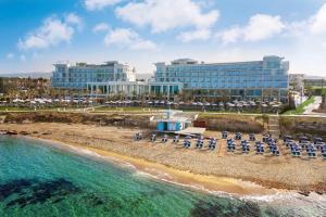 an aerial view of a beach with a hotel at Amavi, MadeForTwo Hotels - Paphos in Paphos