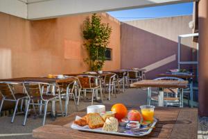 a tray of food on a table in a restaurant at Ibis Budget Aubenas in Aubenas