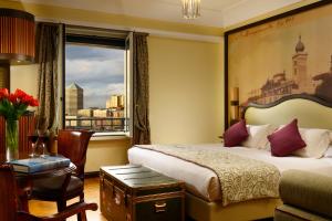 a hotel room with a bed and a window at Grand Hotel Savoia in Genoa
