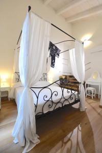 a bedroom with a bed with curtains on it at Casa delle Rocche in Monteu Roero