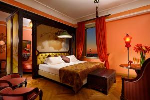 a bedroom with a bed and a table and chairs at Grand Hotel Savoia in Genoa