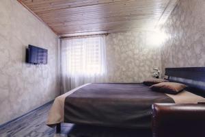 a bedroom with a large bed with a window at Hotel Fortuna in Lviv