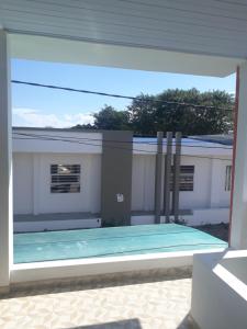 a view of a swimming pool through a window at El Sol in Leticia