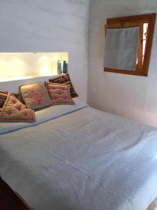 a bedroom with a large bed in a room at La casa dei tramonti in Baja Sardinia