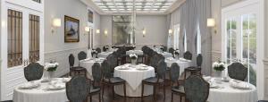 a conference room with tables and chairs and a chandelier at Belleview Inn in Belleair