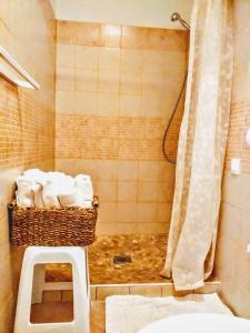a bathroom with a basket of towels and a shower at Apartments Relax Zone in Umag