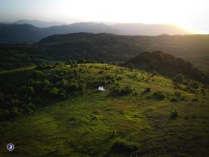 an aerial view of a grassy hill with a tent on it at Guarda Che Luna in Sasso di Castalda