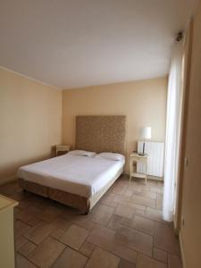 a bedroom with a bed and a tiled floor at Residence Il Vigneto in Oggebbio +50 photos
