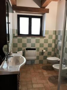 a bathroom with a sink and a toilet at Apartment- Ibisco in Apecchio