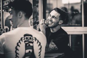 a man getting a tattoo on a mans back at St Christopher's Inn Camden in London