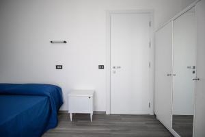 een slaapkamer met een blauw bed en 2 kasten bij Hotel B&B Sole in Senigallia