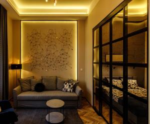 a living room with a couch and a bed at E13 - Elegant Apartment in Budapest