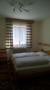 a bedroom with a large bed in front of a window at Appartamento N. 7 in Livinallongo del Col di Lana