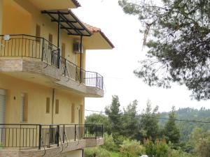 a building with balconies on the side of it at Villa Platskos vol3 in Kriopigi