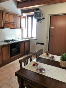 a kitchen with a table with two plates of fruit on it at Appartment- Betulla in Apecchio