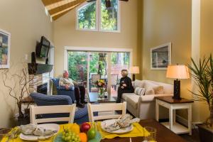 two people sitting in a living room at Oceanside Village Resort in Parksville