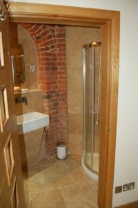 a bathroom with a shower and a sink at The Hyde Dovecote, Kinver in Stourbridge