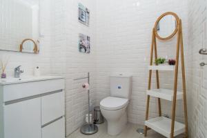 a white bathroom with a toilet and a sink at Luz Apartments in Portimão +33 photos