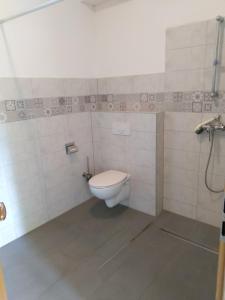 a bathroom with a white toilet in a room at Obala 111 in Poljica