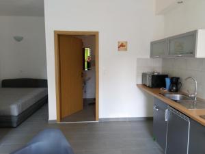 a kitchen with a door leading into a living room at Obala 111 in Poljica +13 photos