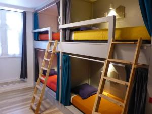 a room with two bunk beds and a fire place at Gite Makila in Saint-Jean-Pied-de-Port