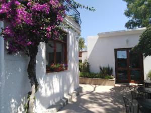 a white building with flowers in a window at Hotel Rio Claro in Fondi