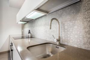 a kitchen with a stainless steel sink and a window at Lake Home Holiday in Como +130 photos