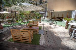 a patio with tables and chairs and an umbrella at Sicily Luxury B&B in Catania