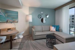 a living room with a couch and a table at Zota Beach Resort in Longboat Key