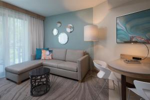 a living room with a couch and a table at Zota Beach Resort in Longboat Key