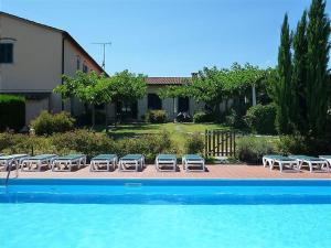 a group of lounge chairs and a swimming pool at Bilocale Agriturismo in Pistoia
