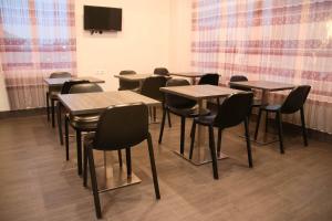 a group of tables and chairs in a room at Super OYO 1006 Azzahra Guest House Syariah in Ambon