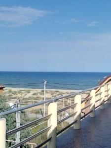 a train on the beach with the ocean in the background at Дом на берегу Черного Моря in Zatoka