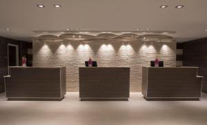 a lobby with a brick wall with lights on it at Zota Beach Resort in Longboat Key