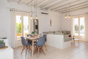 a living room with a table and chairs and a couch at Sorokos Suite 8 in Naxos Chora