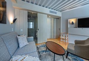 a living room with a couch and a table at Porta Nova Collection House in Braga