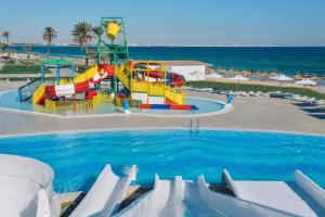 a pool at a resort with a water slide at Iberostar Selection Kuriat Palace in Monastir
