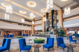 a lobby of a hospital with blue chairs and tables at Iberostar Selection Kuriat Palace in Monastir
