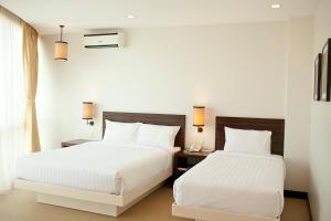 Postel nebo postele na pokoji v ubytování D'Hotel & Suites