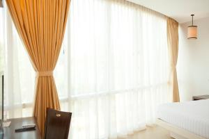 Postel nebo postele na pokoji v ubytování D'Hotel & Suites