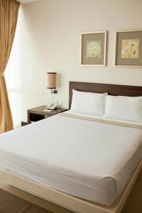 Postel nebo postele na pokoji v ubytování D'Hotel & Suites