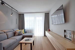 Televízia a/alebo spoločenská miestnosť v ubytovaní Apartament PIER 72 PREMIUM