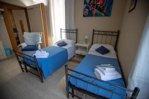 a bedroom with two beds and a chair in it at B&B Sicily Luxury in Catania