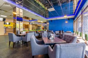a restaurant with blue walls and tables and chairs at Tourist Hotel Complex in Kyiv