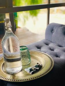 a bottle of water sitting on a tray on a table at Luxe Private 2 bedroom cottage full kitchen in Healesville